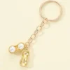 Tradera Ny i sealad förpackning- Guldförgylld Rolig nyckelring med jordnöt & 2 vita pär> Nyckelringar & Nyckelfodral
